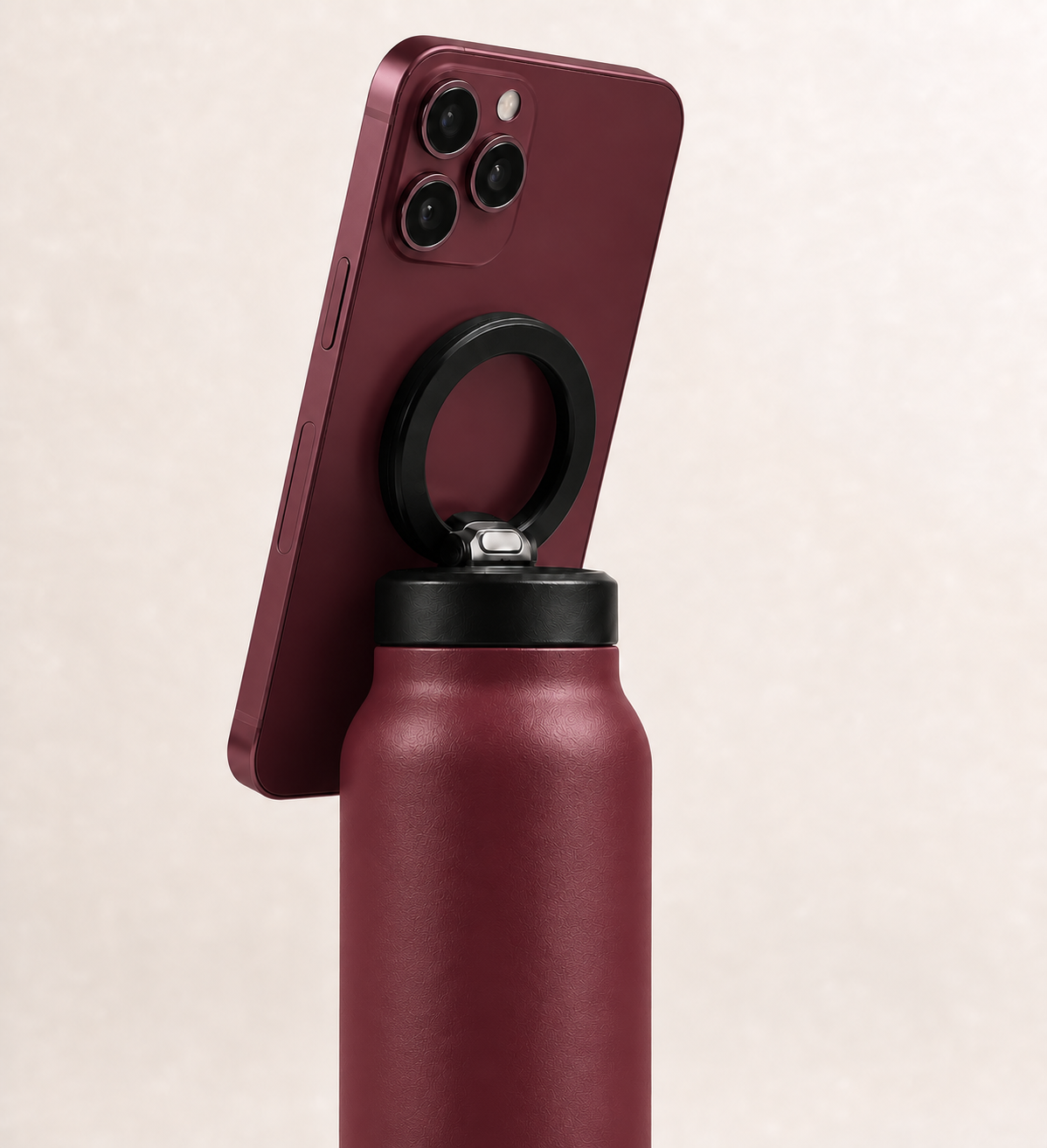 Burgundy i Sheesh bottle holding a matching burgundy phone with the black ring magnet